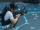 A man with a game gun playing in virtual reality