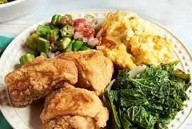 fried chicken on a plate with sides