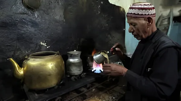 Man making coffee in kitchen in Yemen