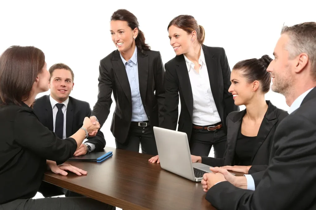 Business meeting with professionals shaking hands, showing collaboration.