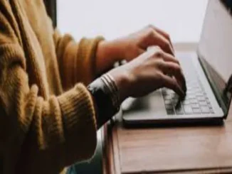 a man with relevant experience working on a laptop