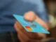 Cryptocurrency coins (Bitcoin, Solana) transforming into a prepaid card, symbolizing fast and cheap purchases in 2025.
