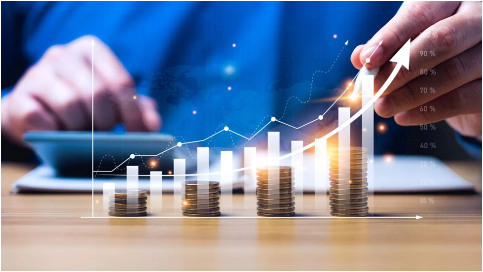 Financial growth concept: rising coin stacks with positive trend charts and hands in the background.