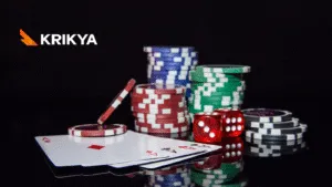 Close-up of casino chips, dice, and playing cards, with the Krikya logo subtly placed in the background.
