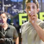 A young man, likely a marketing professional, writes on a clear glass board with a white marker, while another man, perhaps a colleague, is blurred in the background. The text on the board appears to be notes or diagrams related to business or strategy.
