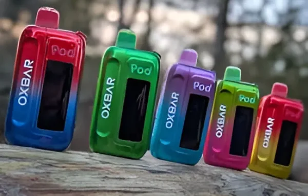 Oxbar Ice-Nic Disposable Vape Devices Five colorful Oxbar Ice-Nic disposable vapes in red/blue, green, blue/purple, pink/green, and yellow/red gradients, lined up on a textured surface.