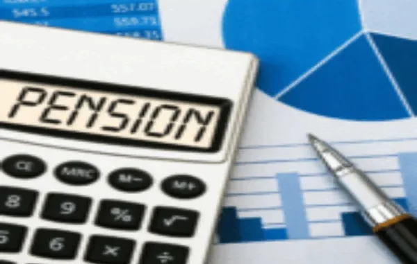 A calculator showing the word "PENSION" on its display, placed on top of financial documents with charts and numbers, alongside a pen.