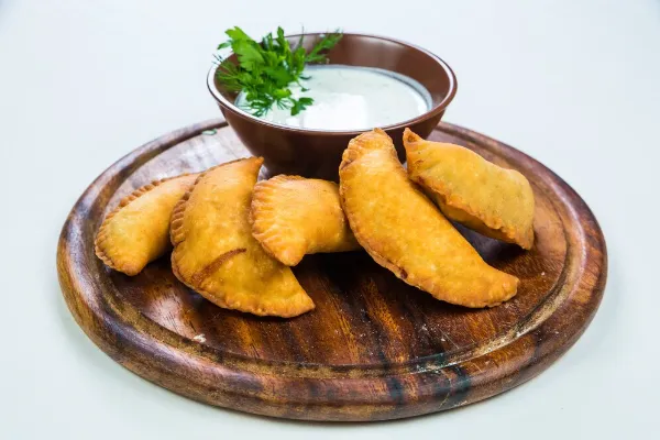 Assorted Colombian breads and savory street foods displayed on a plate.