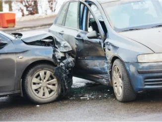 Two damaged cars after a collision at an intersection.