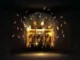 A glowing golden slot machine displaying three sevens (777) with coins spinning around it on a dark background, representing online slots and potential winnings.