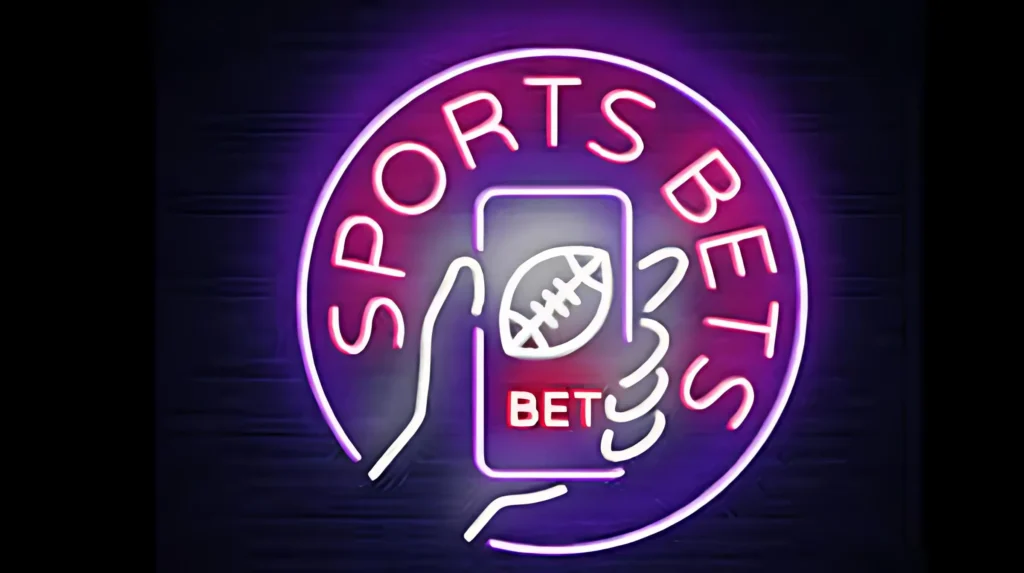 A neon sign graphic with purple and pink glow, depicting a hand holding a smartphone with a football icon and "BET" text on its screen, encircled by the words "SPORTS BETS", representing online sports betting.