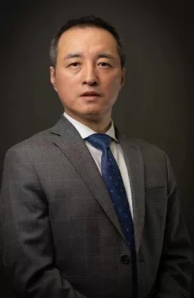 Headshot of attorney Chong Ye, dressed in a suit and tie, representing Ye Law Firm's dedication to justice.