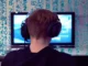 A gamer wearing a headset looks at a screen with numerical data overlaid, symbolizing the technical and detailed nature of optimizing CS2 settings.