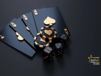 Close-up of four black aces with gold accents, two gold and black poker chips with a heart symbol, and two black dice with gold pips, representing casino games.