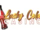 Lucky Cola Casino logo featuring a vintage red soda bottle and the words "Lucky Cola Casino" in stylized gold and red text.