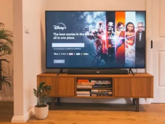 A smart TV displaying the Disney+ home screen, showcasing a modern living room setup with a soundbar and media console, illustrating the widespread adoption of streaming services.