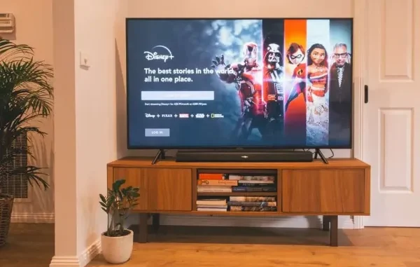 Modern Streaming Experience on a Smart TV A smart TV displaying the Disney+ home screen, showcasing a modern living room setup with a soundbar and media console, illustrating the widespread adoption of streaming services.