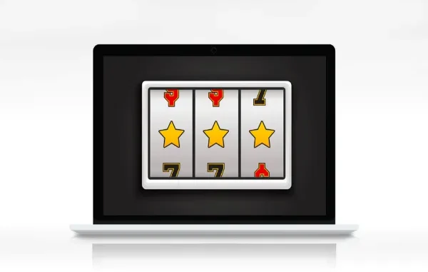 A laptop displaying an online slot machine with three reels showing gold stars, symbolizing online casino gaming and potentially a winning combination.