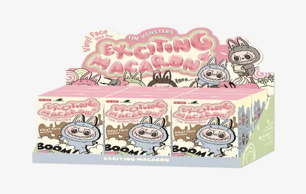 A display box of POP MART "The Monsters Exciting Macaron" blind boxes, featuring various mischievous rabbit-like characters (Labubu and friends) in pastel colors.