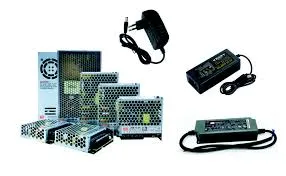 A variety of LED power supplies in different sizes and form factors, including a large industrial unit, a desktop model, and a smaller plug-in adapter.