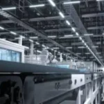 Interior of a brightly lit, modern LED power supply factory with automated production lines and machinery.