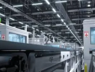 Interior of a brightly lit, modern LED power supply factory with automated production lines and machinery.