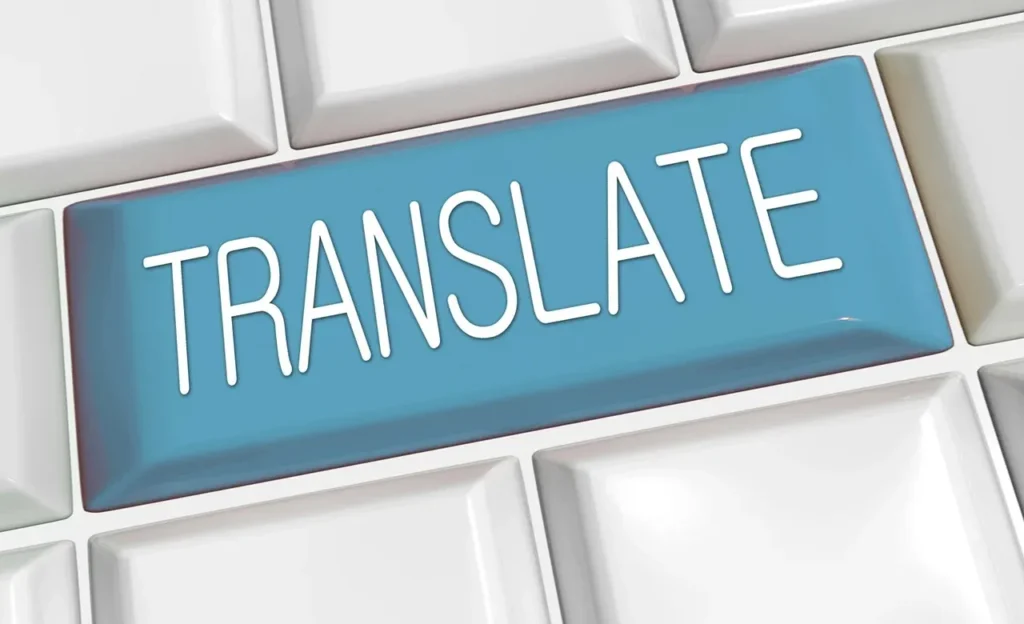 A close-up of a computer keyboard with a prominent, large blue key featuring the white word "TRANSLATE" on it, surrounded by other plain white keys.