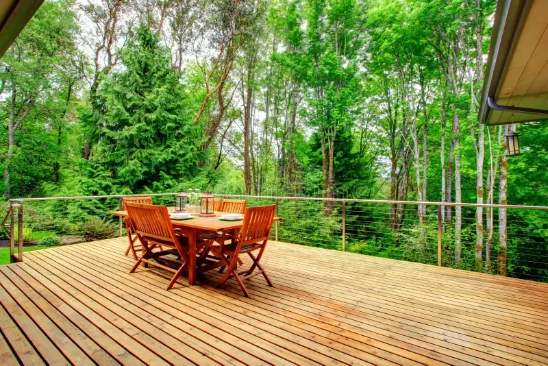 backyard deck overlookinga mazing nature landscape view served-wooden table green forest