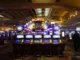 A brightly lit, prominent bank of poker-themed video slot machines in a casino, featuring a large "POKER" sign with a display showing a jackpot amount of "$4,186.25."