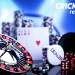 A close-up of a gambling table setup with a roulette wheel, dice, poker chips, and a dealer button, with the "CRICKEX review" logo in the top right corner.
