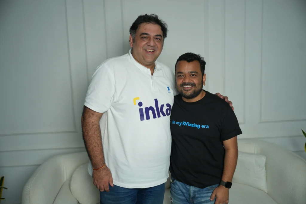 Inka co-founder Tarun Mathur (left, in white Inka polo) and comedian Kumar Varun (right, in "KVIzzing era" black t-shirt) smiling together.