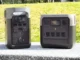 Two portable power stations, one upright and one horizontal, sit outdoors against a grassy background.