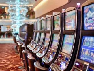A long row of brightly lit slot machines with various game displays in a modern casino, illustrating the diverse options for players seeking to win at slots.