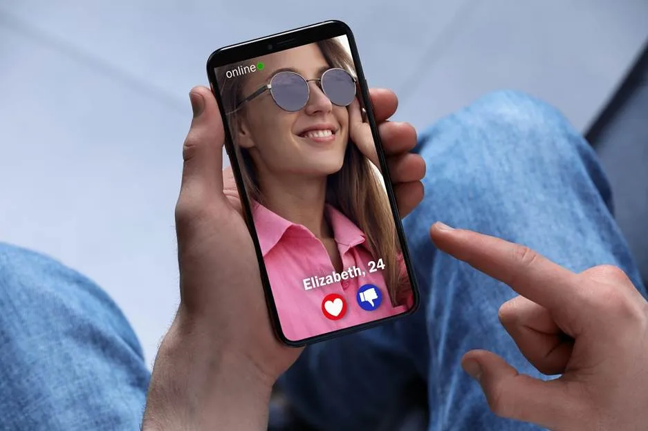 Man viewing a user profile on his phone’s dating app, reflecting how to find someone on Tinder by phone number.