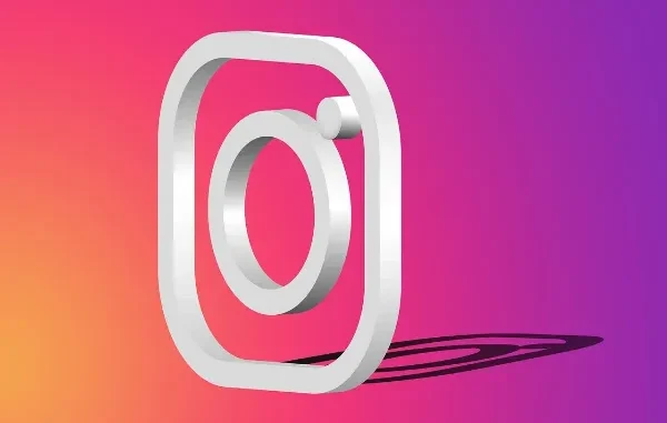 A bold, three-dimensional white outline of the Instagram logo (a camera) casting a shadow against a vibrant purple, orange, and pink gradient background, symbolizing social media monetization and content creation.