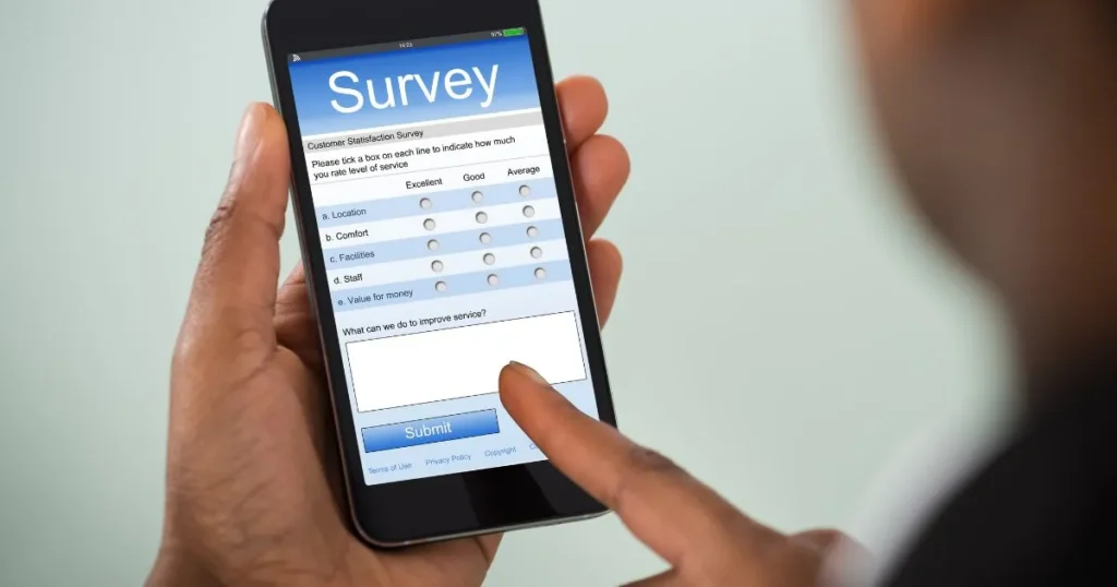 A person using a smartphone to complete paid online surveys to earn extra money at home.