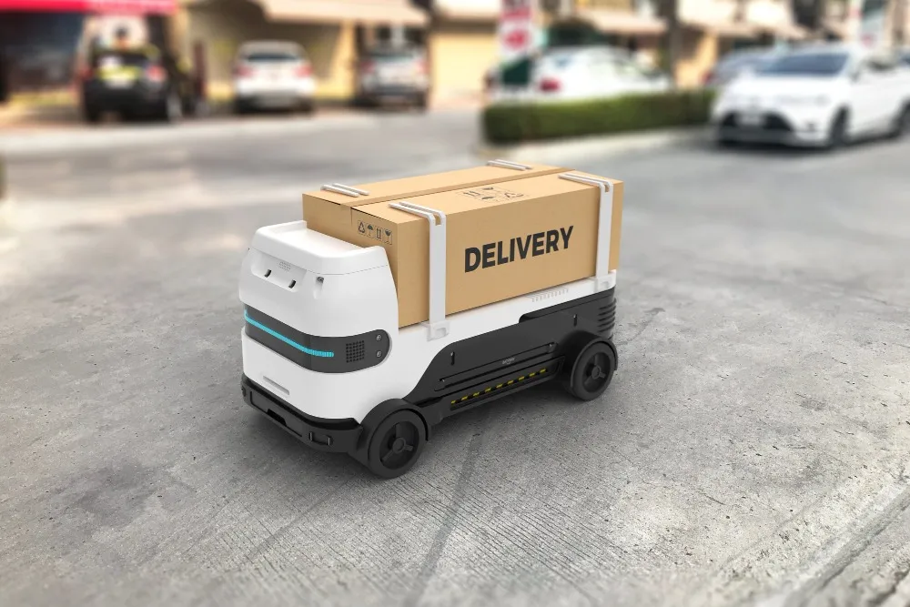 A sleek, white and black autonomous delivery robot carrying a large cardboard box labeled 'DELIVERY' on a city street, representing modern last-mile logistics solutions.