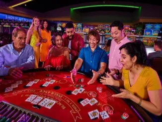 A diverse group of excited friends playing blackjack at a brightly lit casino table with cards and chips visible.