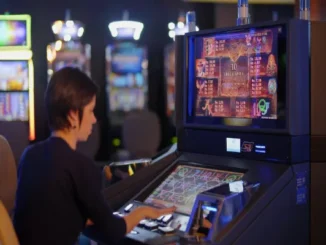 A woman sitting at a modern slot machine in a casino, focusing on the digital screen displaying game symbols, payout multipliers, and "10 Free Games" bonus information.