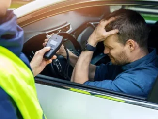 A law enforcement officer conducting a roadside sobriety check on a driver in Dallas, highlighting the legal risks of drugged driving in Texas.