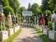 A curved path in a garden lined with mannequins on pedestals, each dressed in clothing styles representing different Kibbe body types like Flamboyant Natural, Romantic, and Soft Gamine.