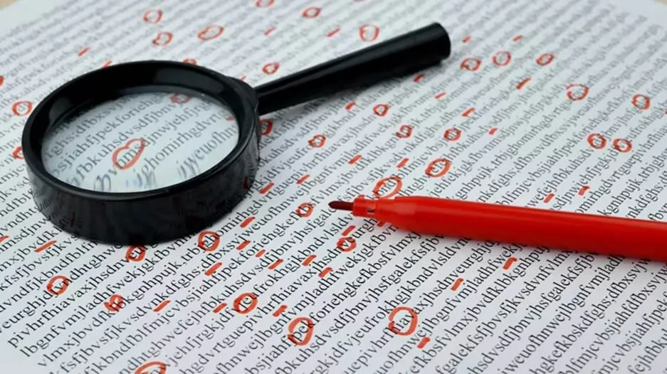 A close-up of a document filled with jumbled letters, with several red circles highlighting specific sections. A magnifying glass rests on the page, and a red marker pen lies nearby, symbolizing the process of detailed text analysis and error detection.