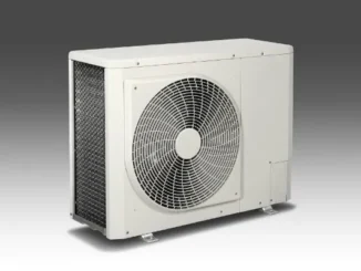 A side-profile view of a clean, modern white outdoor HVAC condenser unit with a large circular fan grille and metal cooling fins.