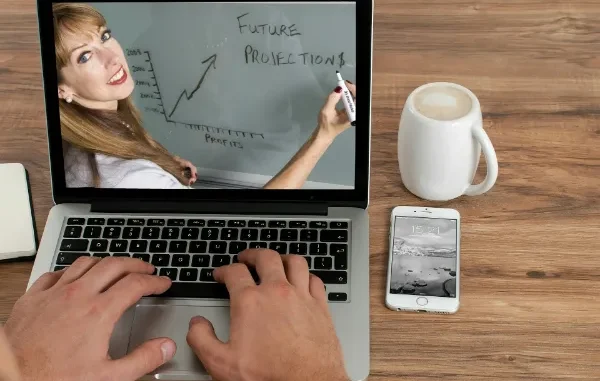 A professional focusing on a laptop, symbolizing a Simplilearn learner utilizing career support and job assistance tools to achieve growth in 2026.