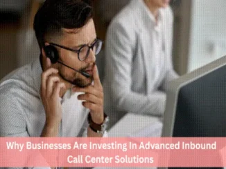 A professional male call center agent wearing a headset and glasses, looking thoughtfully at a computer screen in a modern office environment.