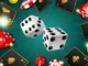 A 3D illustration of white and red dice, black playing cards, and casino chips floating over a green radial background.