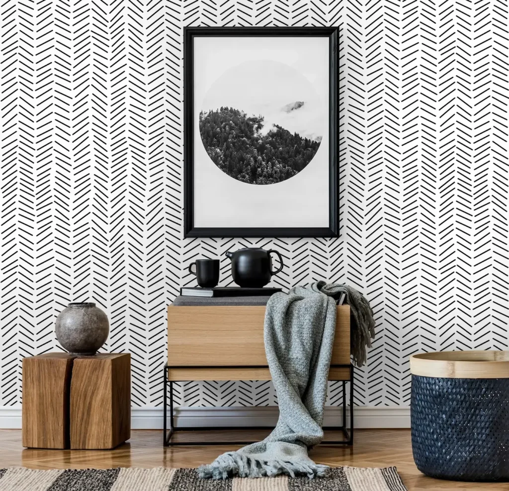 Geometric black and white dashed wallpaper in a contemporary room with minimalist wood furniture.