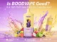 Promotional image for the BOODVAPE MIXR 7-in-1, featuring a yellow and purple disposable vape device with a lion mascot. The device is surrounded by splashing liquid and fresh fruits like dragon fruit, guava, blueberries, and lime, with the headline "Is BOODVAPE Good? Is a High-Puff Vape Right for Everyday Use?