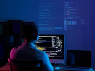 A software developer sitting at a desk with multiple monitors displaying code, terminal windows, and cloud infrastructure dashboards, representing the modern DevOps workflow in 2026.