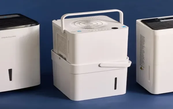 Three different white portable dehumidifiers, including a Frigidaire model and a Midea Cube, showcasing varying tank sizes and designs for moisture removal.